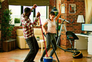 happy-man-and-woman-doing-house-chores-and-dancing-2023-11-27-04-50-30-utc